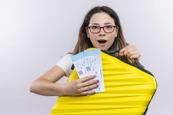 Excited traveler holding verified plane tickets ready