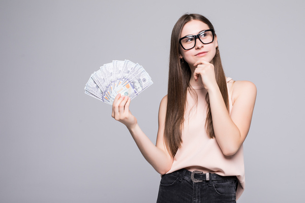 Woman thinking before sending international money transfer