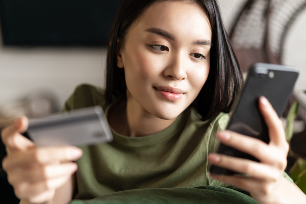 Woman using smartphone for EFT money transfer