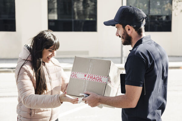A woman uses a courier service to deliver her package
