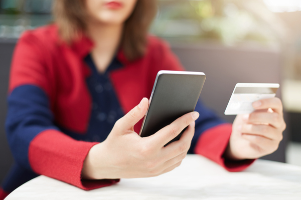 Woman using international mobile top-up to send money

