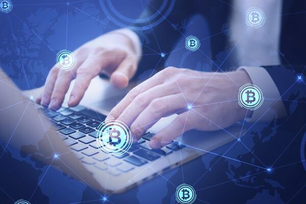 Person using laptop for blockchain money transfer