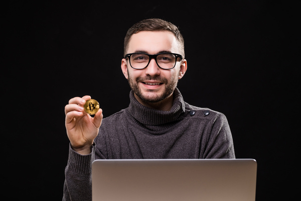 Man holding Bitcoin for ATM transaction