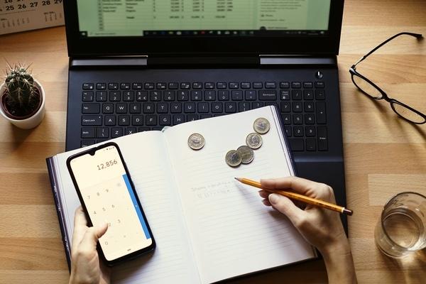 Person calculating their monthly bill payment