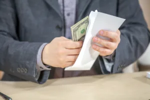 Man receiving cash from envelope after check cashing