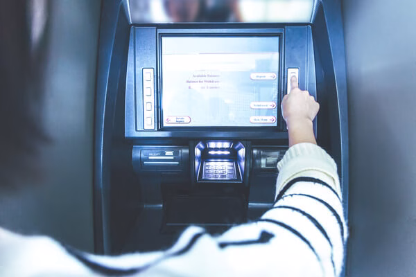 A person using ATM machine for cashing a check