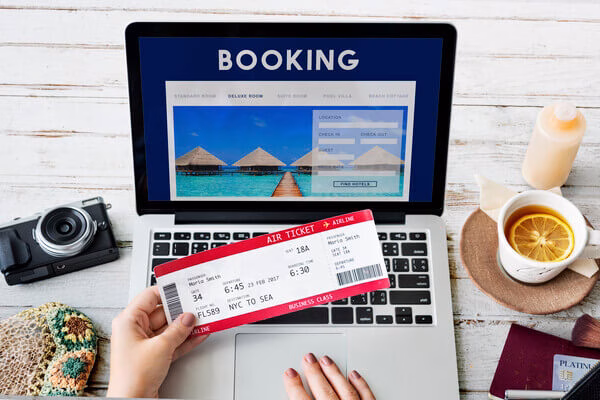 A person is holding a plane ticket

