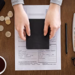 Person filling out a form to deposit a check at a check cashing service