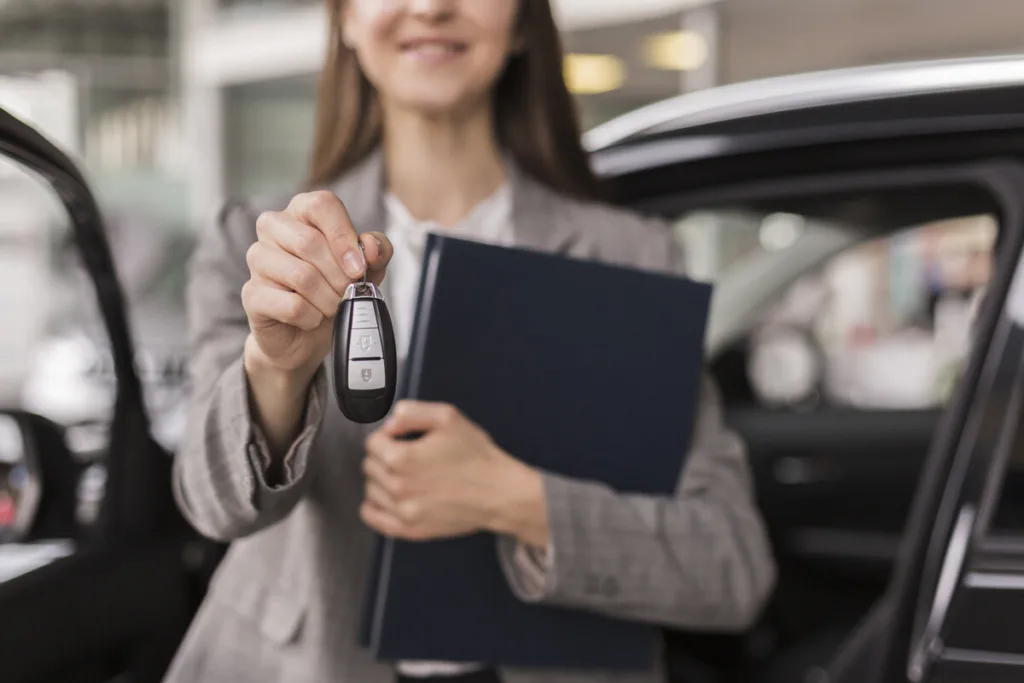Vehicle services representative holding a key and documents