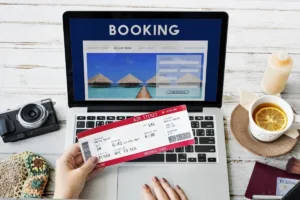 A traveler booking vacation trip using a laptop