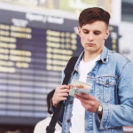 Traveler checking plane tickets at airport terminal