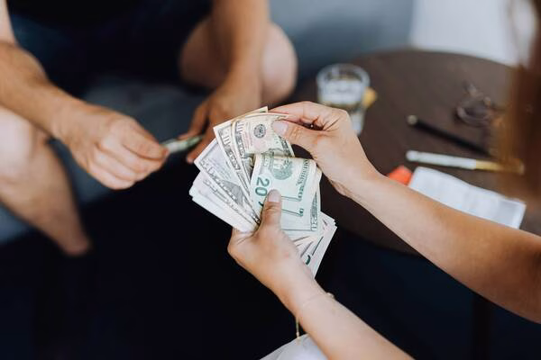 Hands counting money to cash a check save time