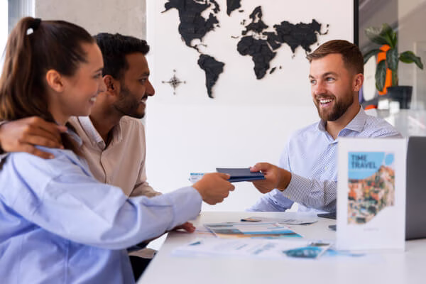 A couple negotiating travel deals with the agent