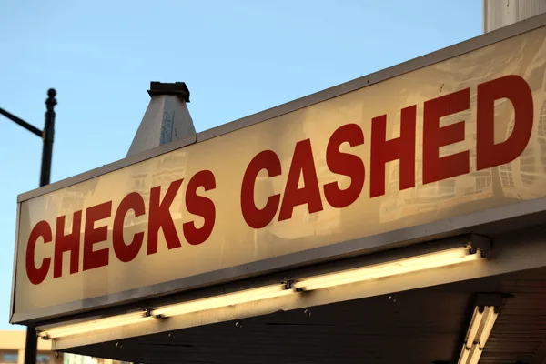 Exterior check cashing shop signage daytime