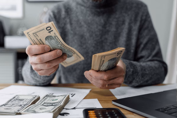 Man Counting Cash For A Money Transfer