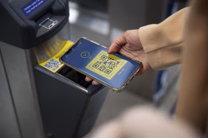 Phone displaying QR code for Bitcoin ATM payment process.
