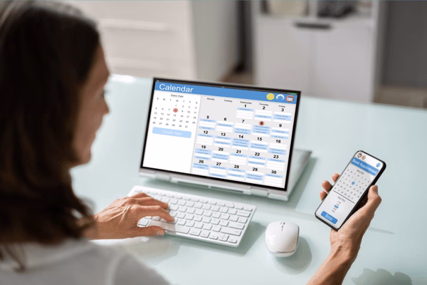 Checking Plane Tickets Dates On Laptop And Phone