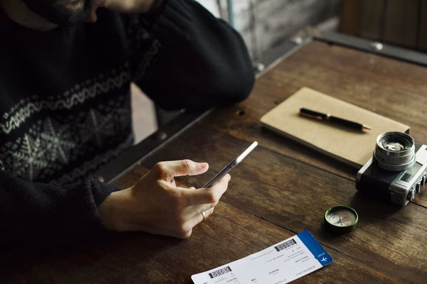 Man checking flight change options by phone
