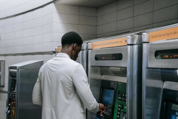 Man using Bitcoin ATM at public location