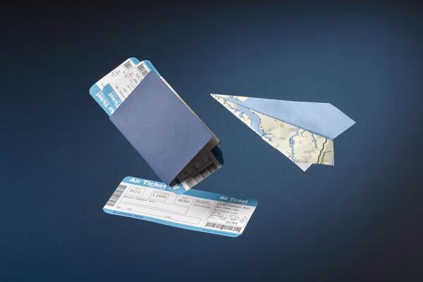 Unused plane tickets with passport and paper plane