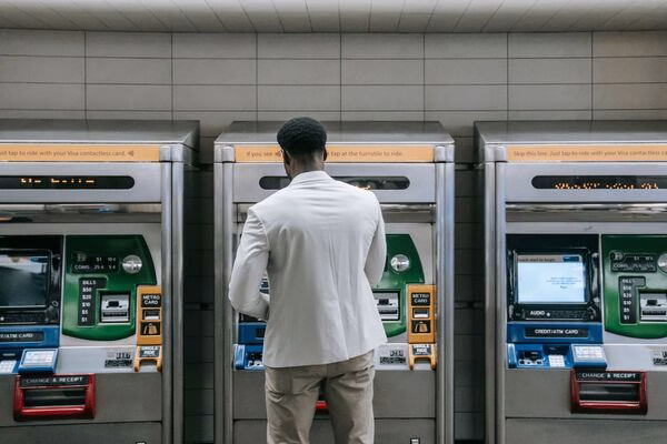 Bitcoin ATM station used by man in white jacket