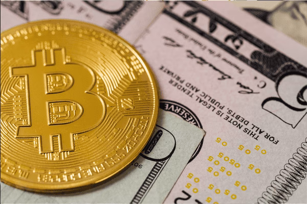 Bitcoin Coin Lying on Multiple Dollar Bills
