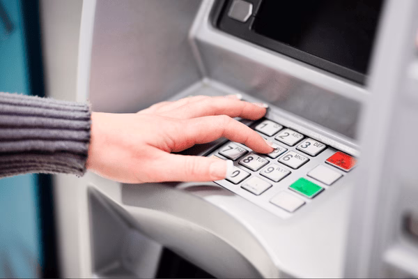 Hand Entering PIN on Bitcoin ATM Keypad