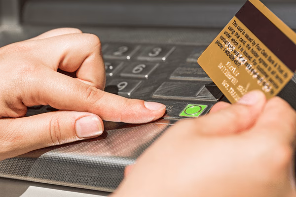 Hand Inserting Card And Using ATM Keypad