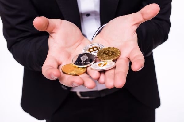 A businessman holding crypto coins with both hands
