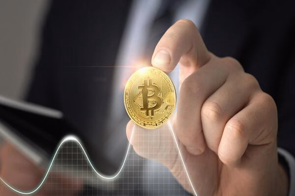 Hand holding Bitcoin symbolizing fast transactions at Bitcoin ATM