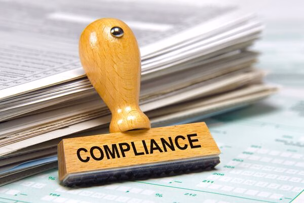 Compliance stamp placed near documents related to Bitcoin ATM regulations.
