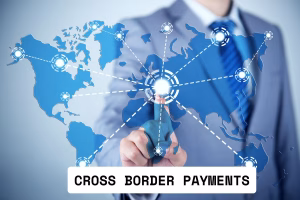 Businessman pointing at global network for Cross Border Payments.