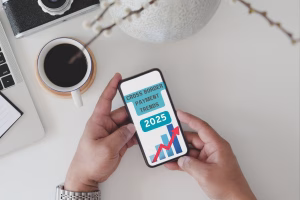 Hands holding phone displaying Cross Border Payments trends 2025