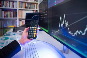 Person analyzing Cross Border Payments data on multiple screens.