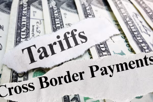 Torn paper reveals Cross Border Payments and Tariffs text headline over U.S. dollars.