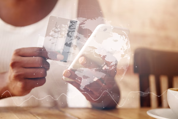 Person managing global payouts on smartphone
