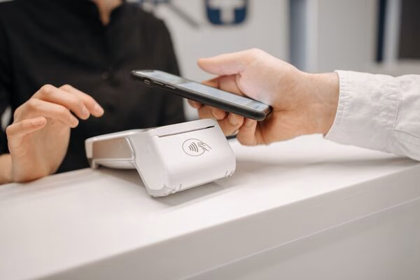 Cross Border Payments made using smartphone at payment terminal.