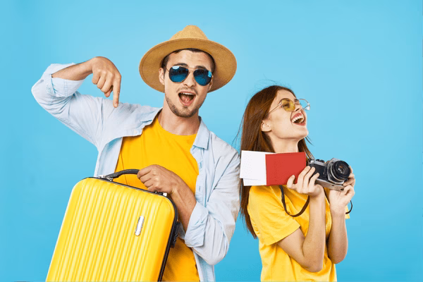 Happy Travelers Holding Camera, Luggage, Plane Tickets