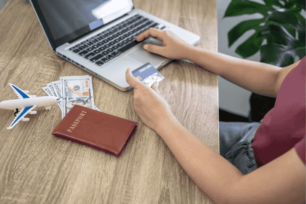 Searching plane tickets on laptop for travel