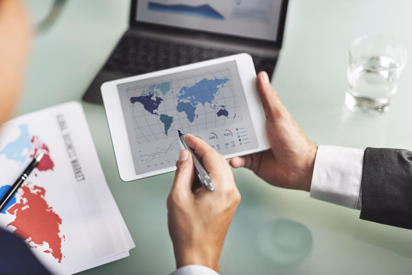 Analyzing Cross Border Payments data on tablet with world map