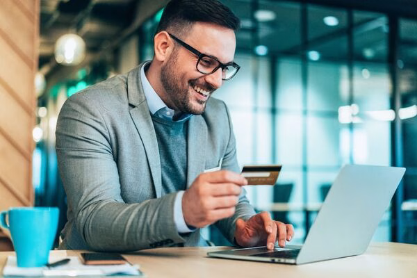 Businessman making Cross Border Payments online using credit card.
