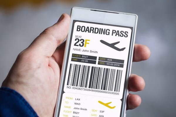 Man holding smartphone showing electronic boarding pass