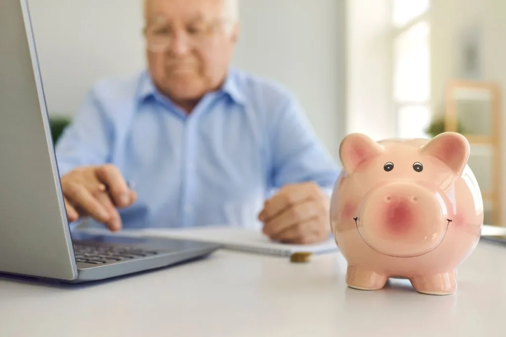 Senior Using Laptop For Secure Money Transfer At Home
