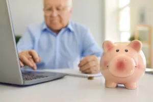 Senior Using Laptop For Secure Money Transfer At Home