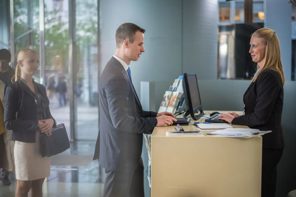 Bank employee assisting client with Money Transfer transaction.