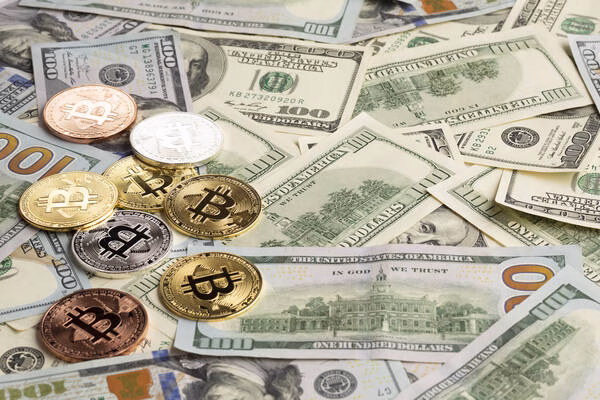 Bitcoin coins on US dollars representing crypto bridge