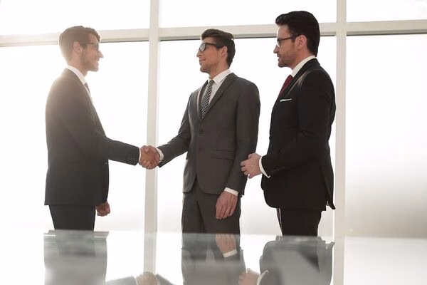 Businessmen handshake symbolizes Cross Border Payments partnership agreement.