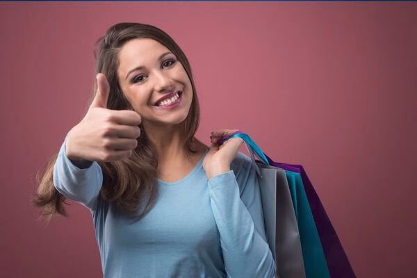 Happy customer showing thumbs up after Cross Border Payments success.