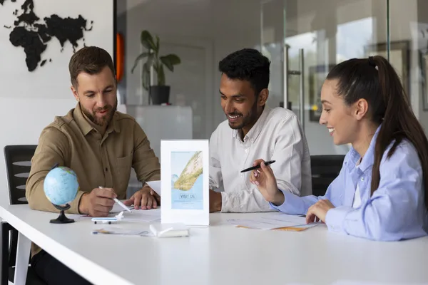 Team discussing international money transfer strategies in modern office.
