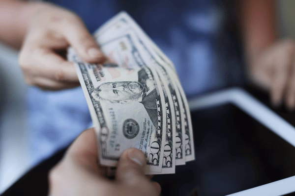 Handing Over Bills During A Money Transfer